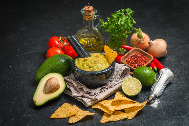 Bowl of delicious homemade Guacamole with nachos - Photo, Image