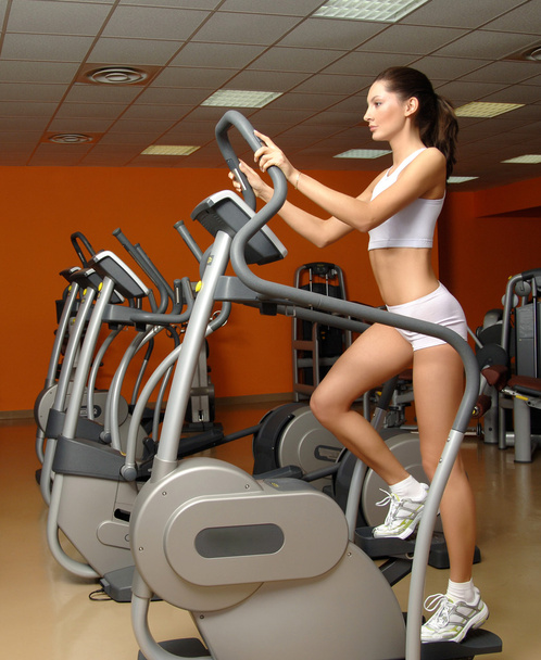 woman training in gym on stepper machine - Photo, Image