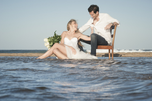couple sitting on the beach  - Zdjęcie, obraz