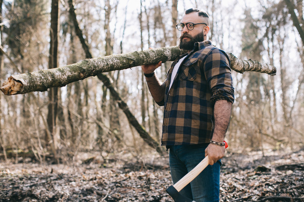 Bearded lumberjack in the wood - Fotó, kép