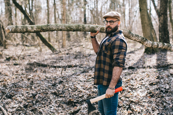 Bearded lumberjack in the wood - 写真・画像