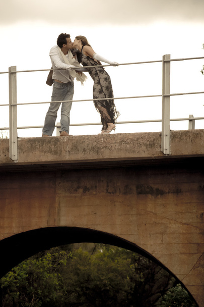 couple on bridge near train tracks  - Zdjęcie, obraz