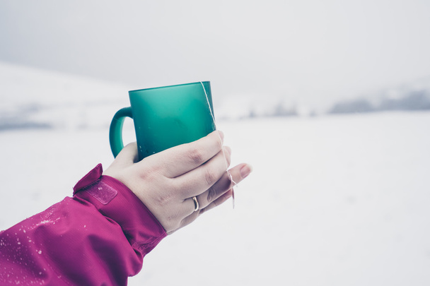 Woman holding green cup with tea - Photo, Image