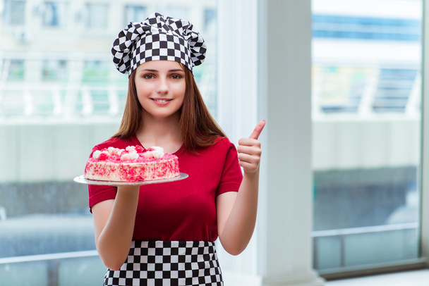 Young housewife baking cake in kitchen - Fotoğraf, Görsel