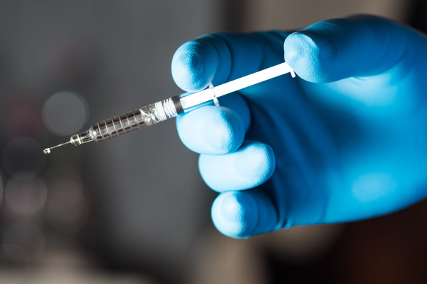 Syringe in doctor or nurse hand. High resolution image. - Foto, immagini