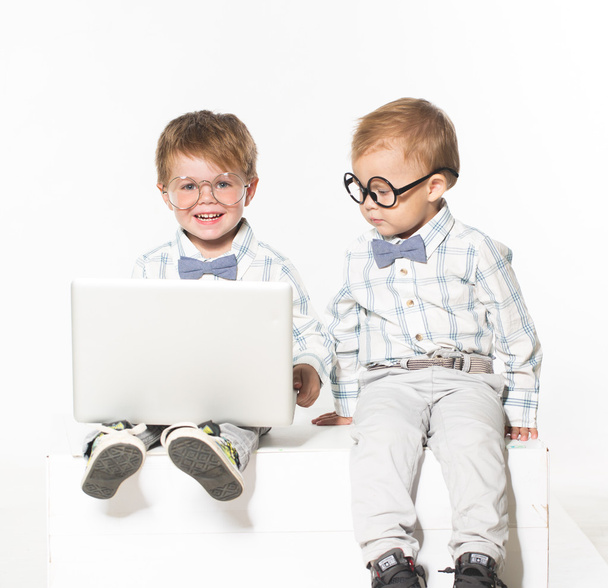 Two cute baby with laptop isolated in studio. - Valokuva, kuva