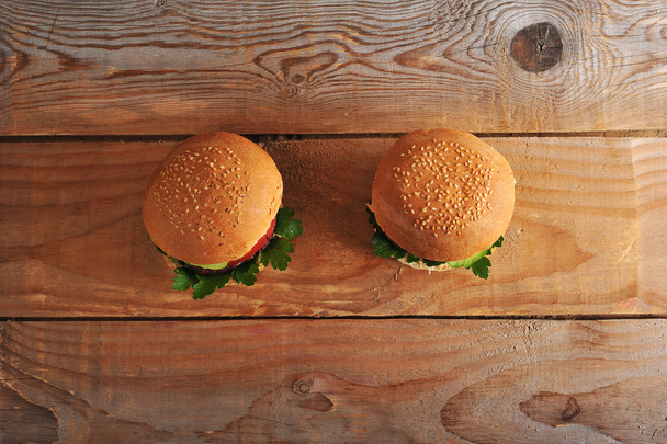 two hamburger on wooden rustic background - Photo, Image