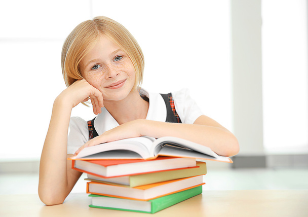 Smiling girl with many books  - Foto, afbeelding