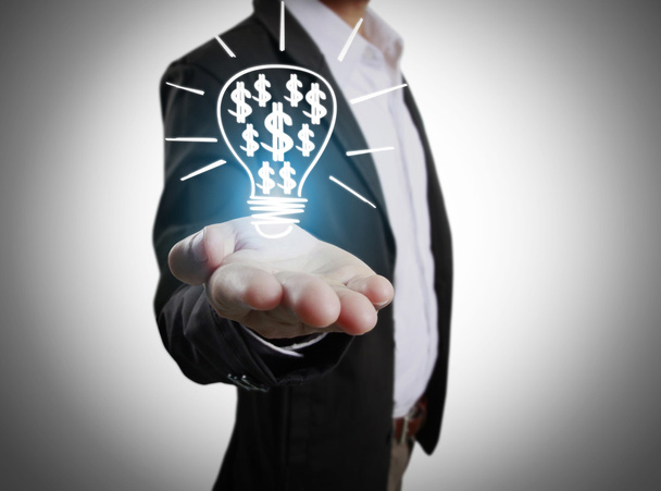  business person holding light bulb  - Foto, Bild