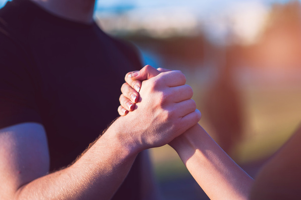 Closeup of male and female handshake outdoors - Foto, immagini