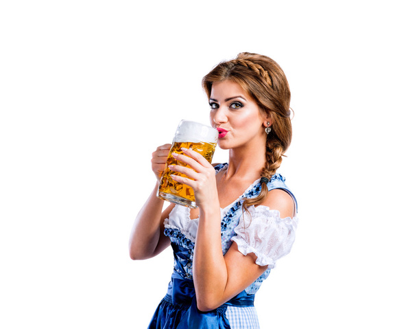 Woman in bavarian dress with beer - 写真・画像