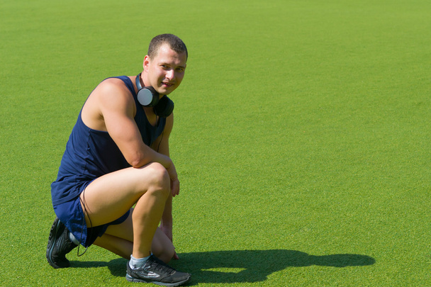 athlete on the background of field - Zdjęcie, obraz