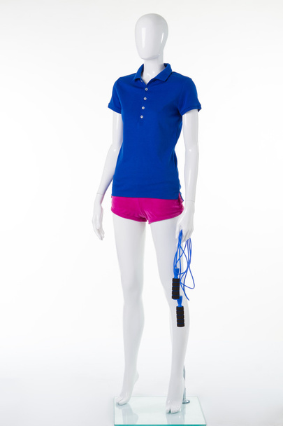 blaues Polo-T-Shirt und rosa Shorts mit Springseil. - Foto, Bild
