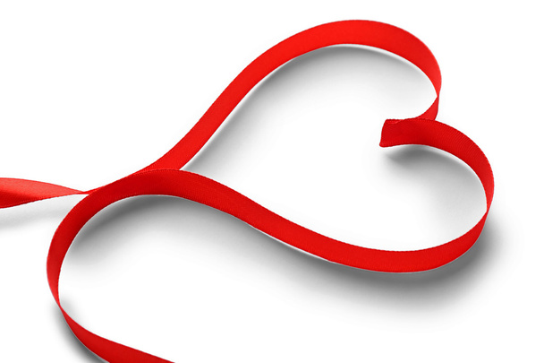 Red ribbon in shape of heart  - Фото, изображение