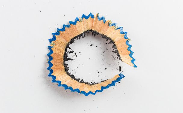 Pencil shaving bark with dust on white paper - Photo, Image