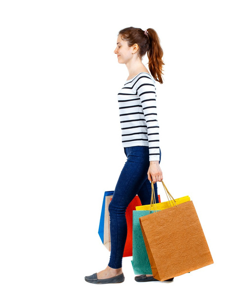 side view of going  woman  with shopping bags . - Photo, Image