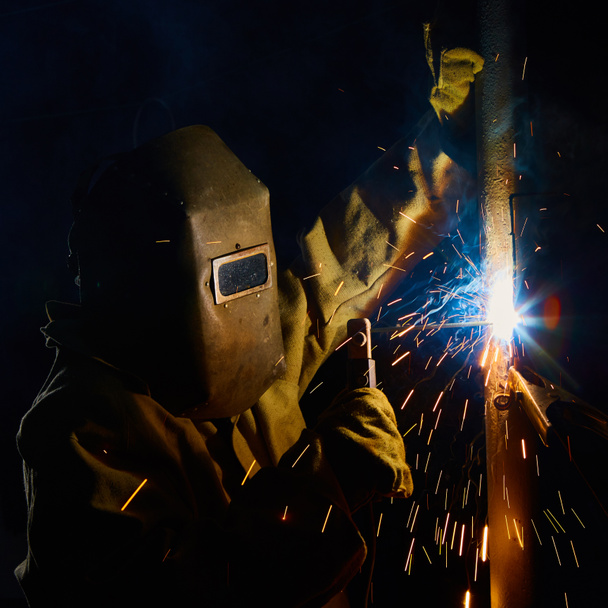 welder worker welding metal by electrode - Photo, Image