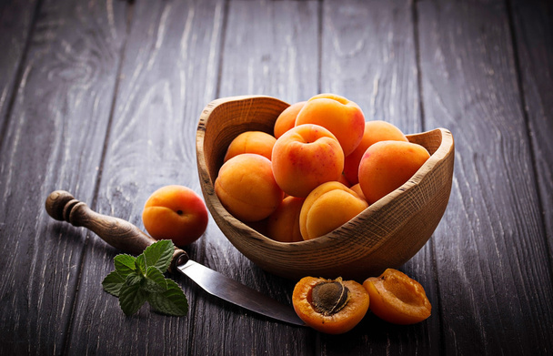 Sweet apricots on wooden background - Фото, изображение
