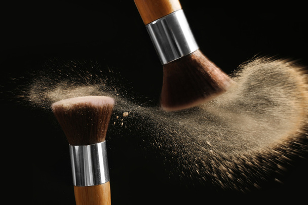 Make-up brushes with beige powder explosion  - Foto, Imagem