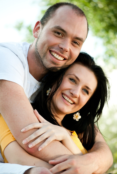 Closeup portrait of smiling young couple in love - Outdoors - Фото, изображение