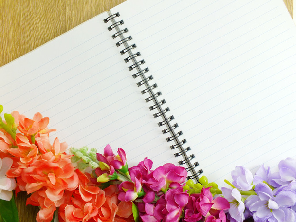 blank notebook diary with pink flower on wooden background - Photo, Image