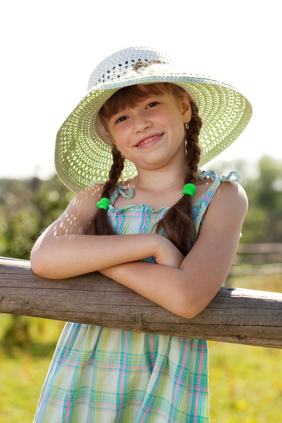 Dark-haired girl in a wicker hat - Photo, Image