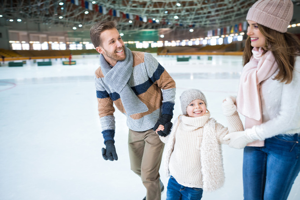 Smiling family at skating rink - Photo, image