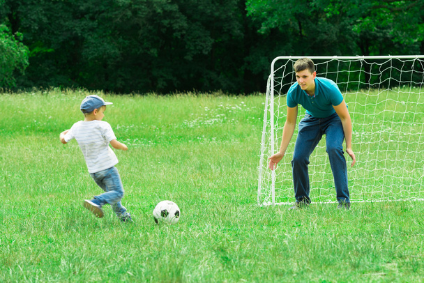 Kid Playing Football With His Father - Фото, изображение