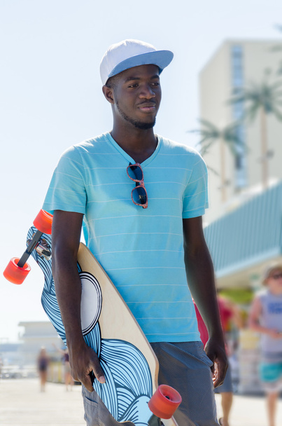 Young African American man with skateboard - Fotoğraf, Görsel