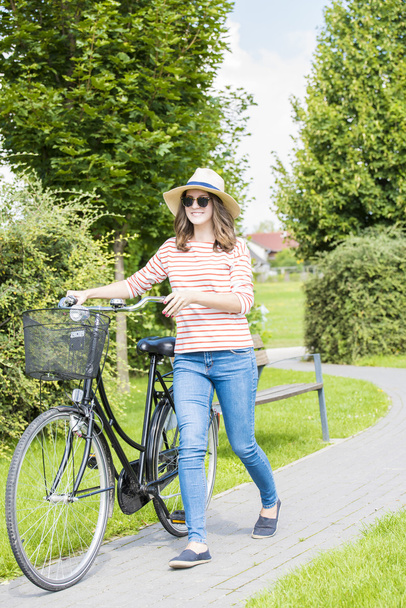 woman with her bike walking - Фото, изображение