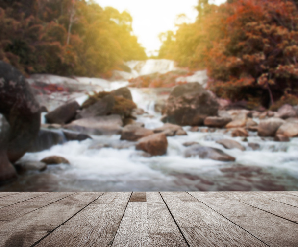 Wood floor top on blurred colorful water fall - Photo, image