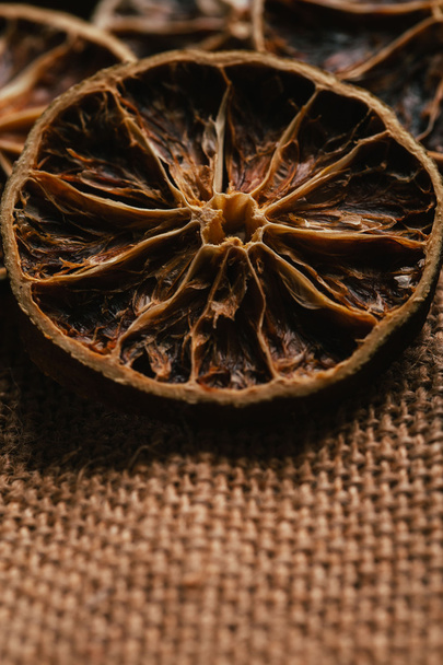 Dried lemon and orange on a light background sacking - Photo, image