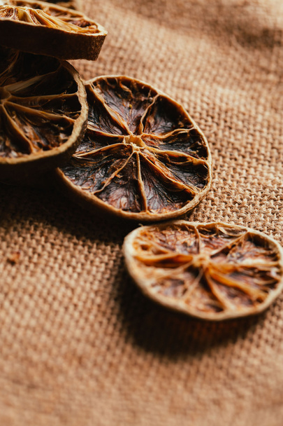 Dried lemon and orange on a light background sacking - Photo, image