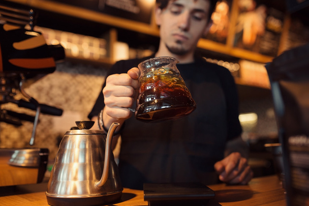 Barista at work in a coffee shop - Фото, изображение