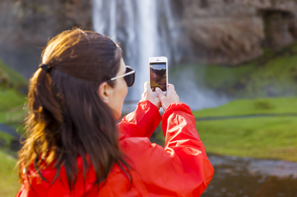 Tourist taking pictures with her mobile phone - Photo, image