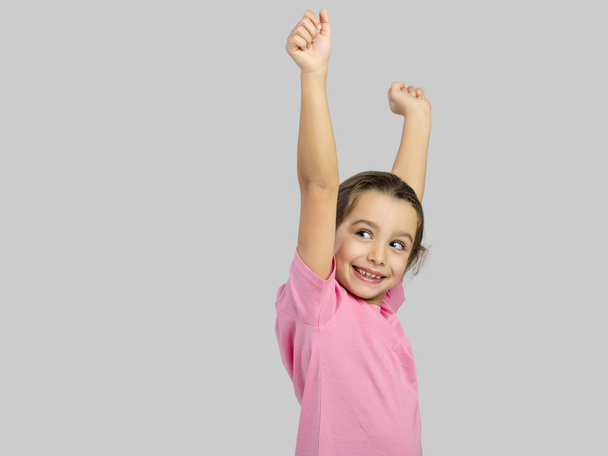 Little girl with arms raised on air - Φωτογραφία, εικόνα