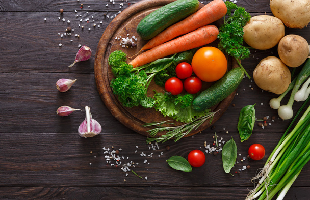 Plenty of fresh vegetables on wooden background with copy space - Photo, Image