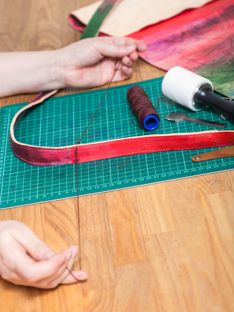 craftsman sews new belt for leather bag - Photo, Image