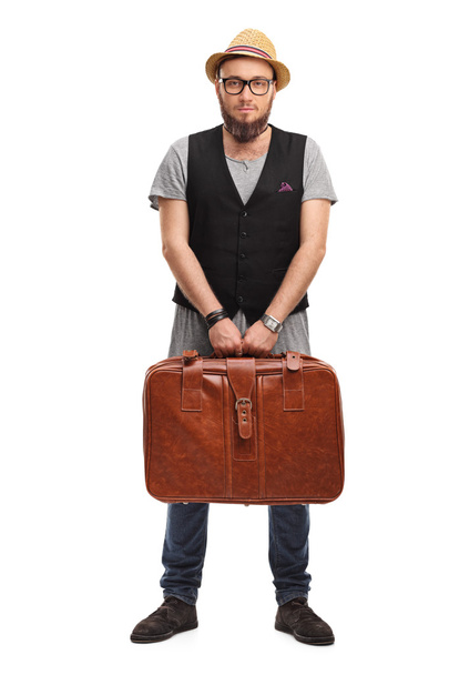 Young hipster holding a suitcase - Fotó, kép