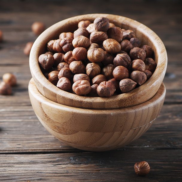 Raw hazelnuts in bowls - Фото, зображення