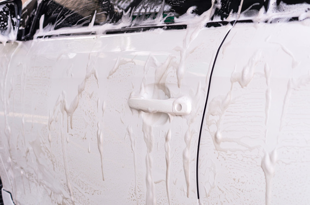 Cleaning car with foam  - Фото, изображение
