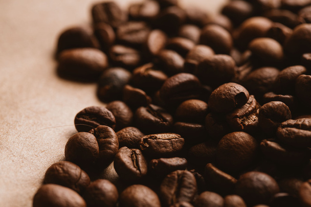 dark coffee beans close-up on light paper - 写真・画像