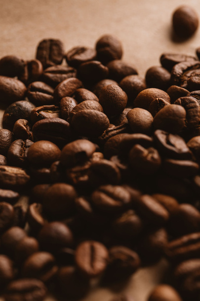 dark coffee beans close-up on light paper - Фото, изображение