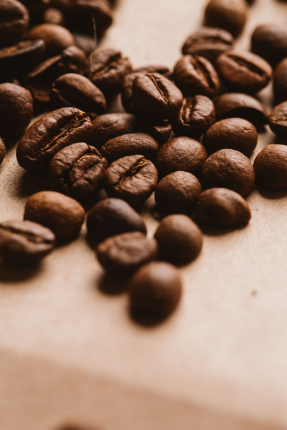 dark coffee beans close-up on light paper - Fotó, kép