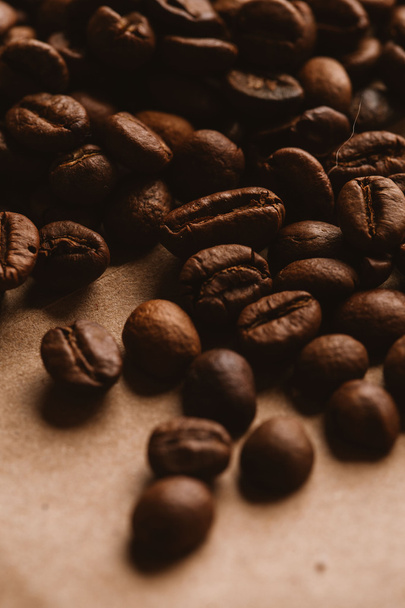 dark coffee beans close-up on light paper - Valokuva, kuva