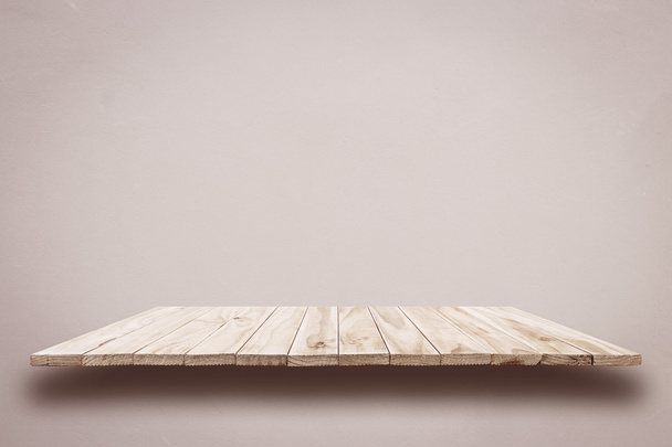 Empty top wooden shelves on grey cement wall  - Фото, зображення