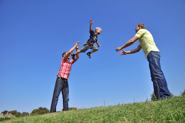 Father throwing his son in the air and c - Photo, Image