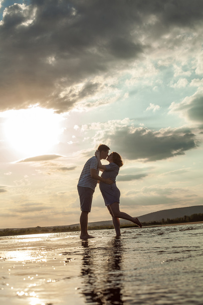 Felice coppia è in piedi in acqua e baci
.  - Foto, immagini
