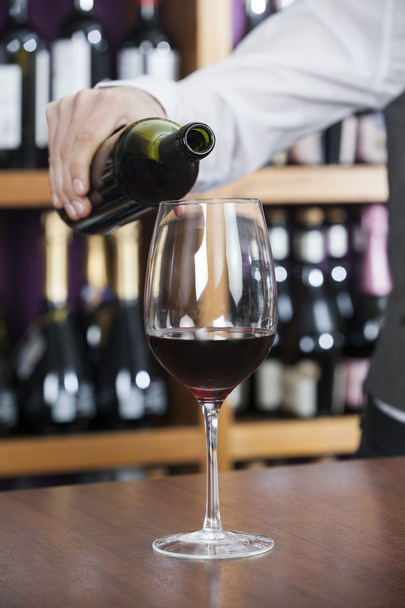 Cropped Image Of Bartender Pouring Red Wine In Glass - Foto, immagini
