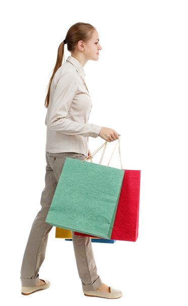 side view of going  woman  with shopping bags . - Foto, immagini